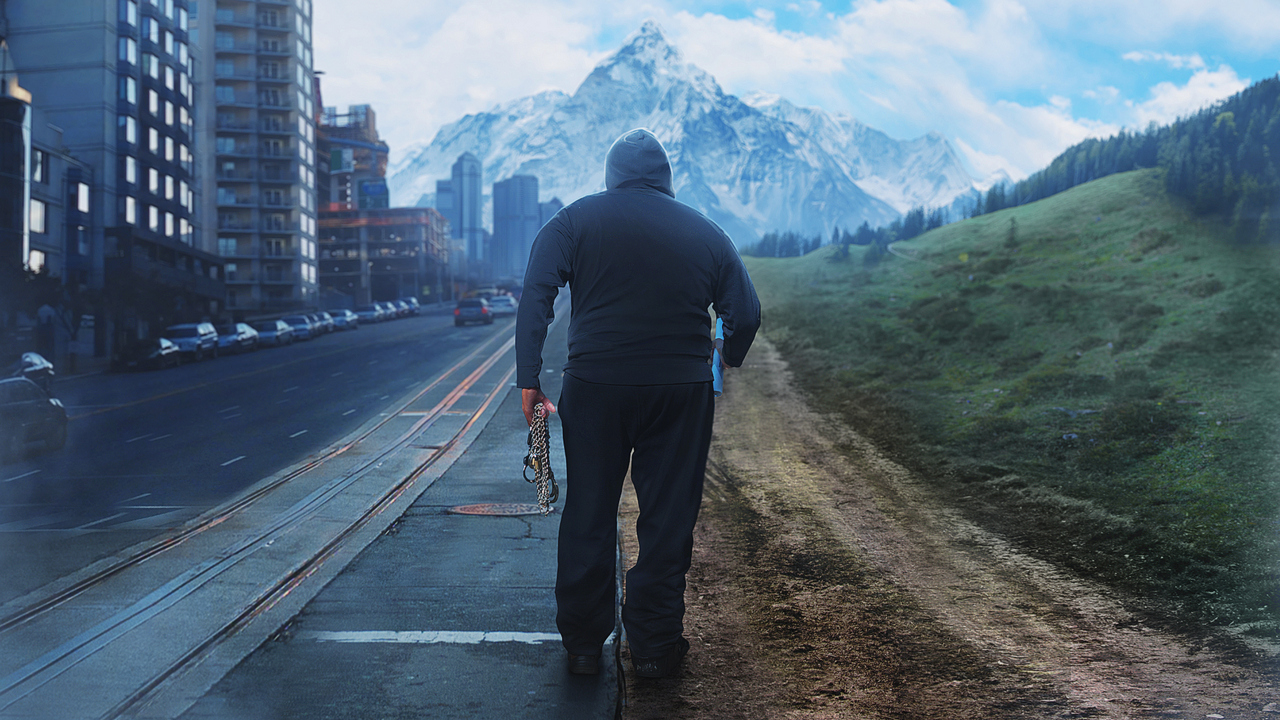 Picture of The Hunter walking through a town and mountainside